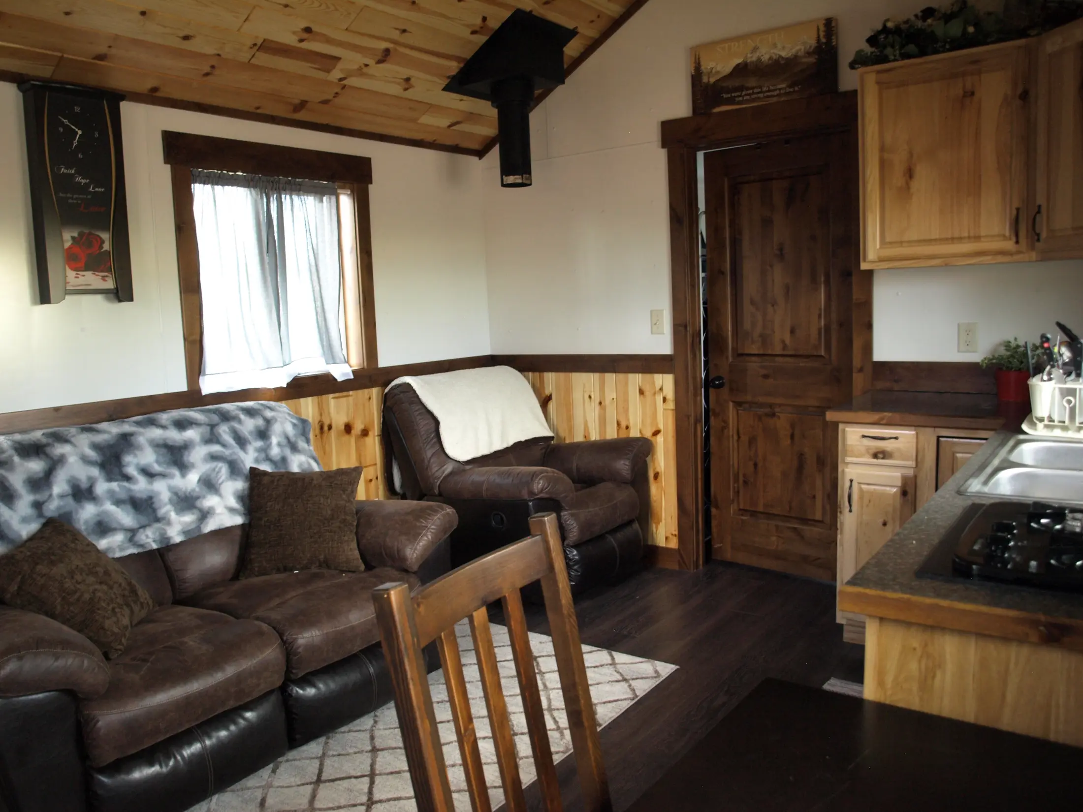 Stargazer cabin living room with hickory cabinets and knotty pine ceiling